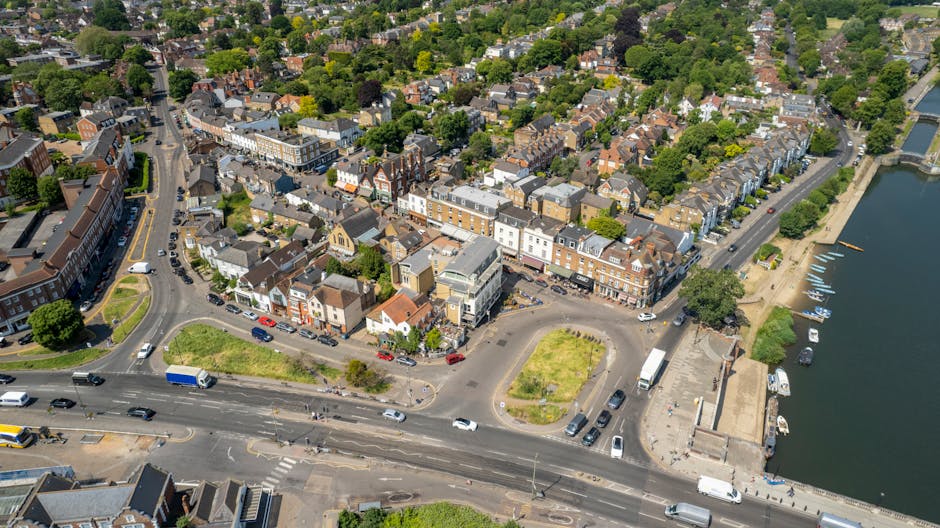 Aerial view of Isleworth TW7 town center featuring a variety of flower delivery shopfronts, including floral arrangement displays outside. The scene includes bustling streets with cars and buses, and 
